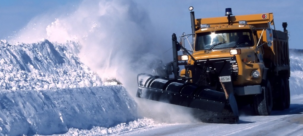 Truck snowplowing a roadway