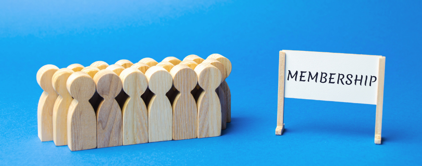 30 wooden figures with a white sign that says membership